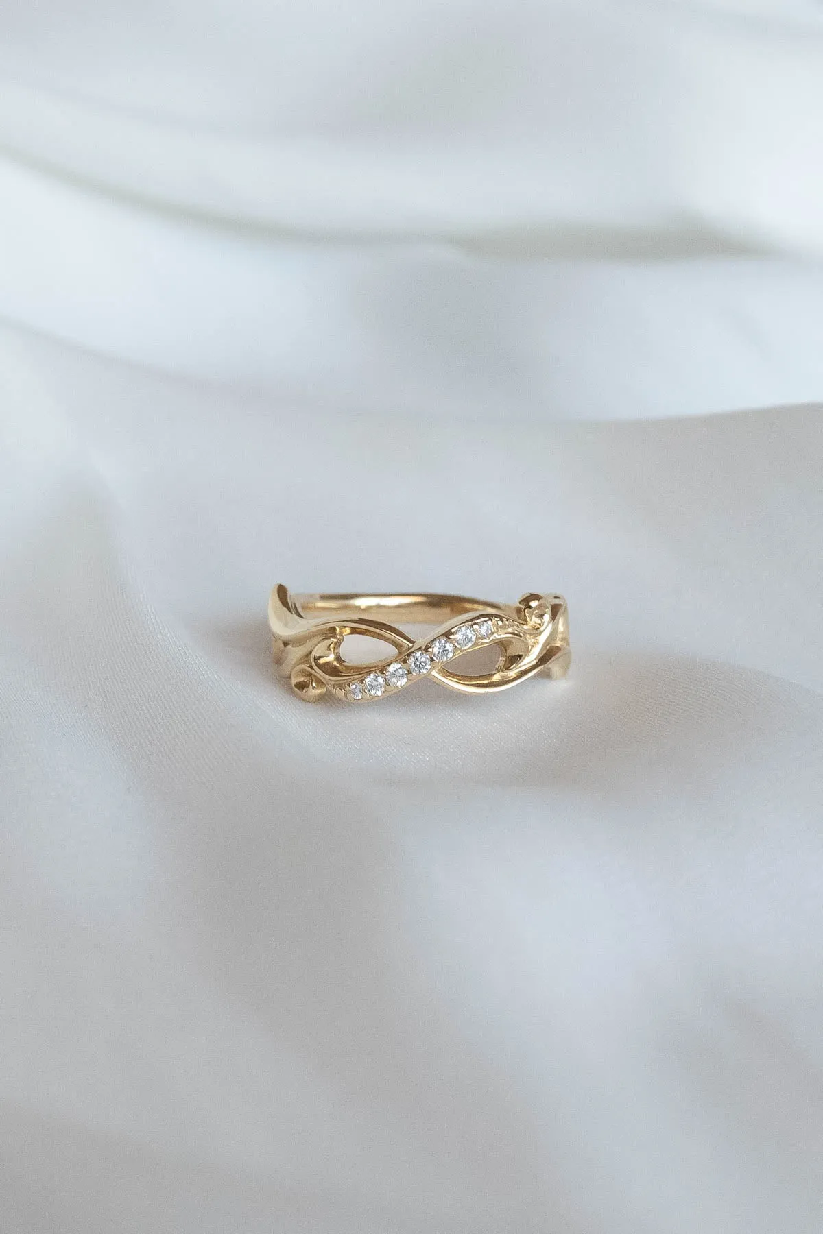 Wedding rings set for couples: gold band for him, infinity band with diamonds for her