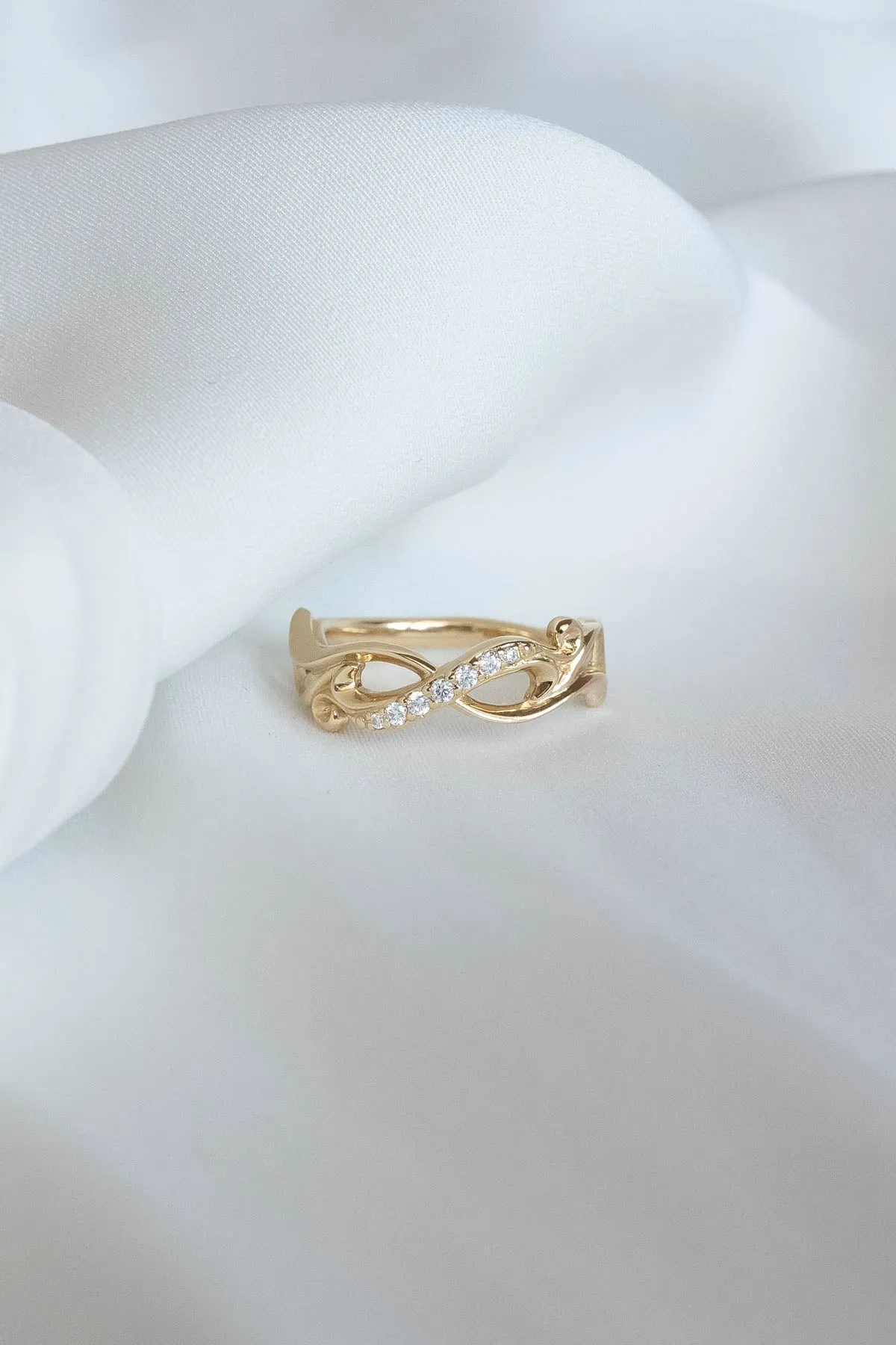 Wedding rings set for couples: gold band for him, infinity band with diamonds for her