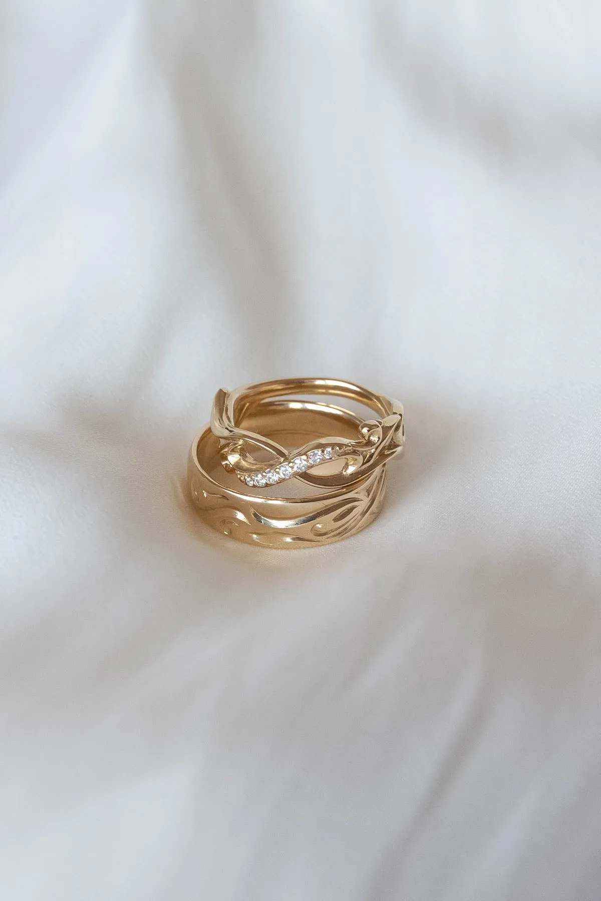 Wedding rings set for couples: gold band for him, infinity band with diamonds for her